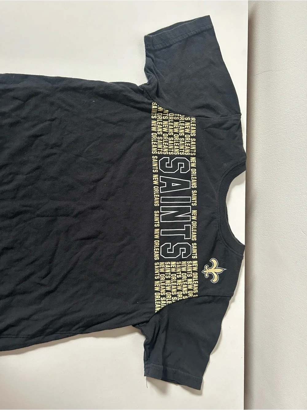 NFL Kids Black Tee with Gold Saints Text and Fleur-de-lis